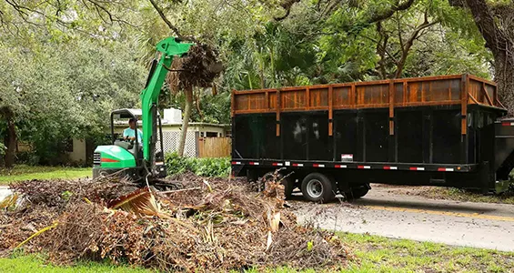 Debris cleanup crew collecting and hauling away tree branches in North Creek, NY.